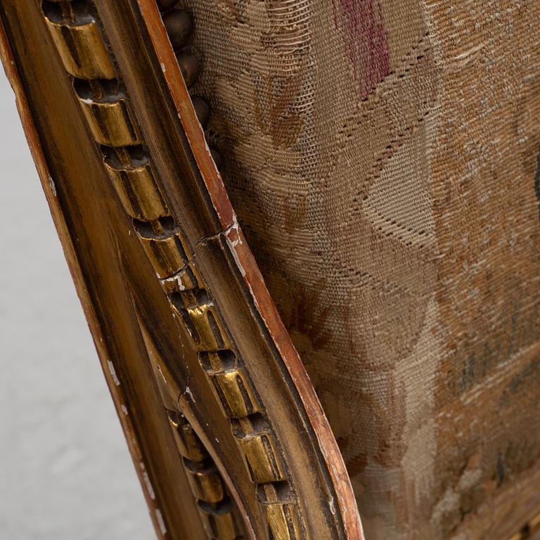 A pair of Louis XVI-style armchairs, late 19th century with 18th century fabric.