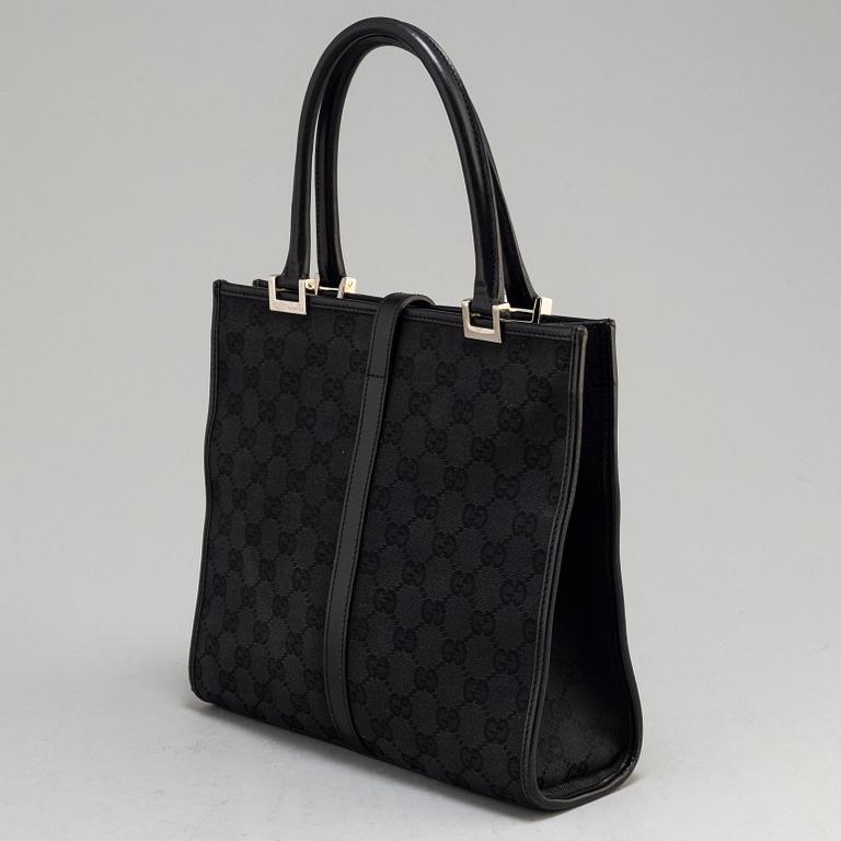 GUCCI, a leather and canvas bag.