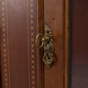 A display cabinet, England, early 20th century.