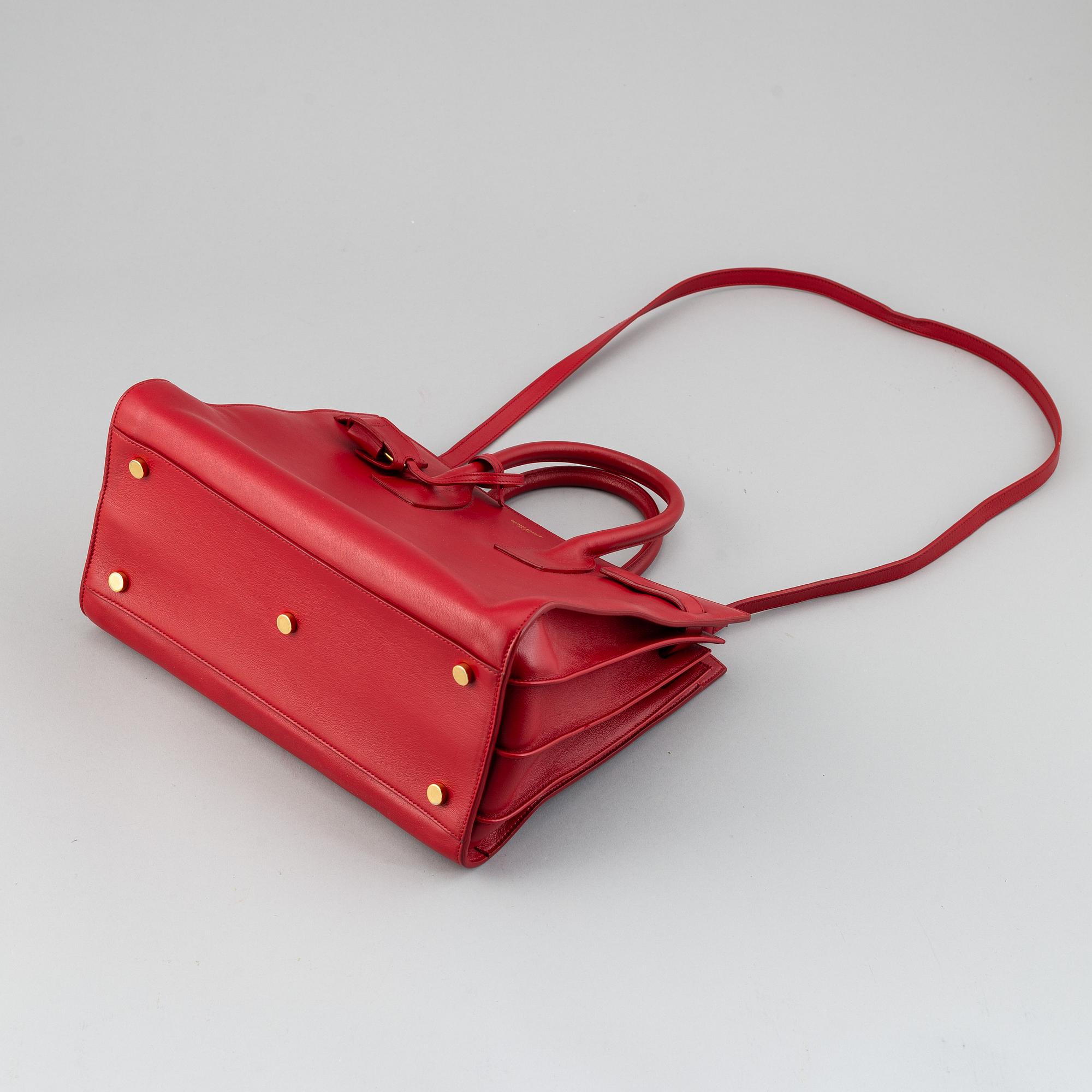 Saint Laurent, a red leather 'Sac du Jour Small' bag.