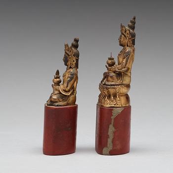 Two Sino-tibetan wooden and lacquered figures of buddha, late 19th Century.