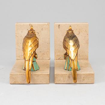 A pair of art déco painted metal and marble books ends, 1930s.