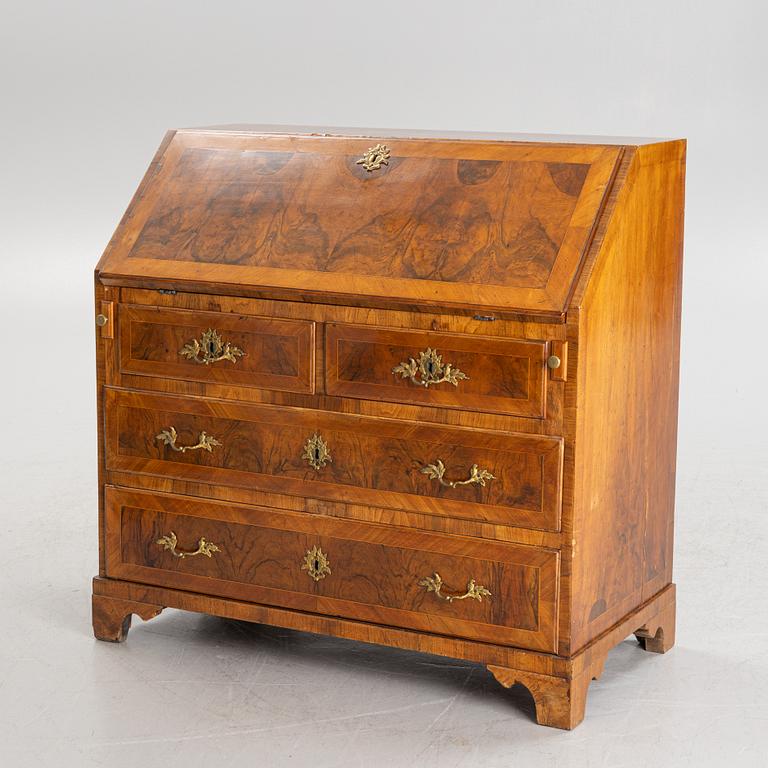 A rococo walnut-veneered and gilt-brass mounted secretaire, later part of the 18th century.