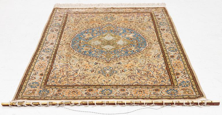 An oriental, silk rug, signed, c. 175 x 125 cm.