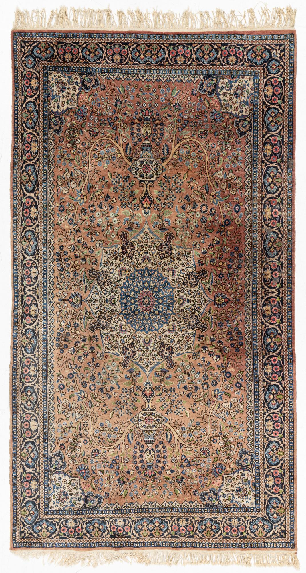 An oriental rug, circa 245 x 136 cm.