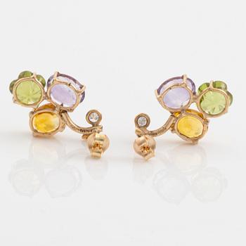 Earrings with yellow sapphires, cut flower-shaped peridot, amethyst, and brilliant-cut diamonds.