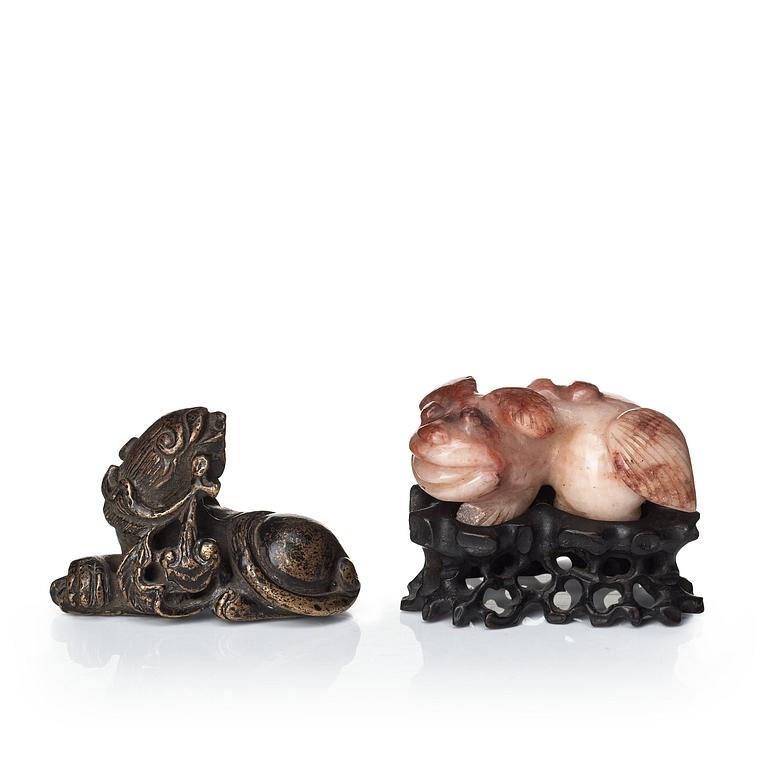 Two sculptures of reclining dogs, Qing dynasty.