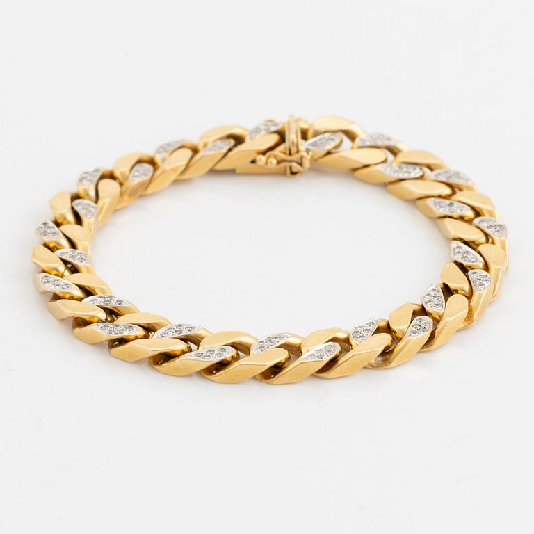 18K gold and brilliant cut diamond curb link bracelet.