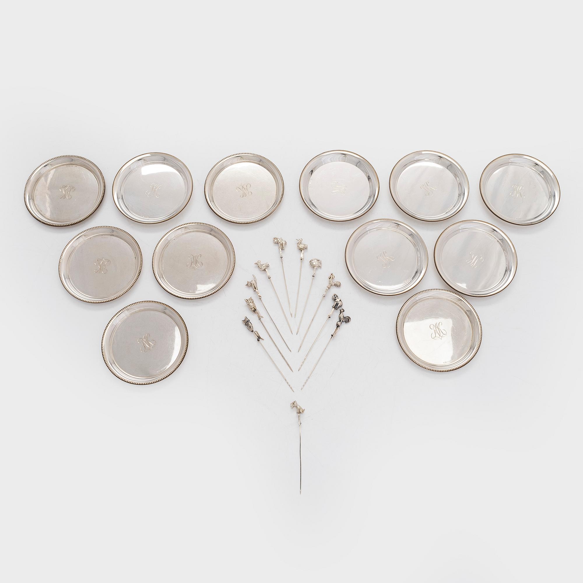 A set of twelve silver coasters and cocktail sticks 11 pcs,  Suomen Kultaseppä Oy 1935 and Kultakeskus 1983.