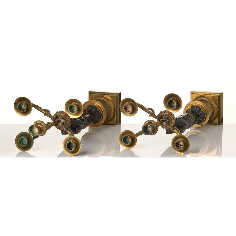 A pair of Fernch Empire ormolu and patinated bronze five-light candelabra, early 19th century.