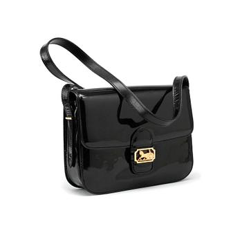 CÉLINE, a black patent leather cross-body bag.