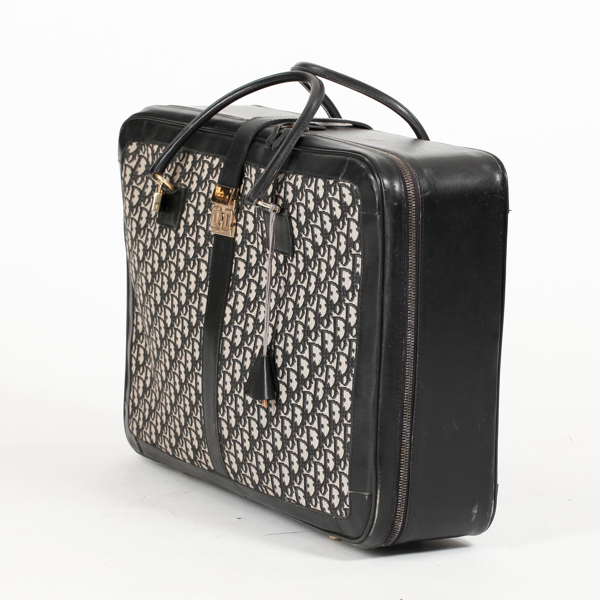 CHRISTIAN DIOR, a black monogram canvas travelling bag.