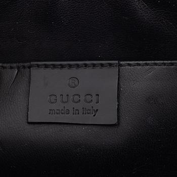 Gucci, a canvas toilet bag.