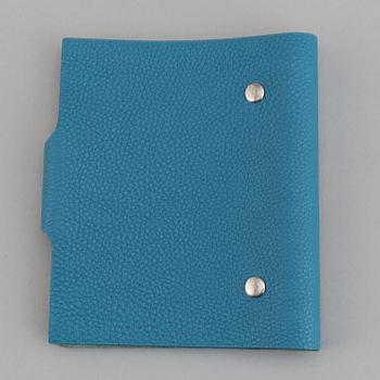 Hermès, a blue leather notebook with two scripple pads.