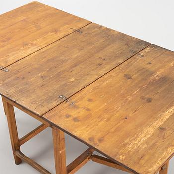 A pine gateleg table, 19th Century.