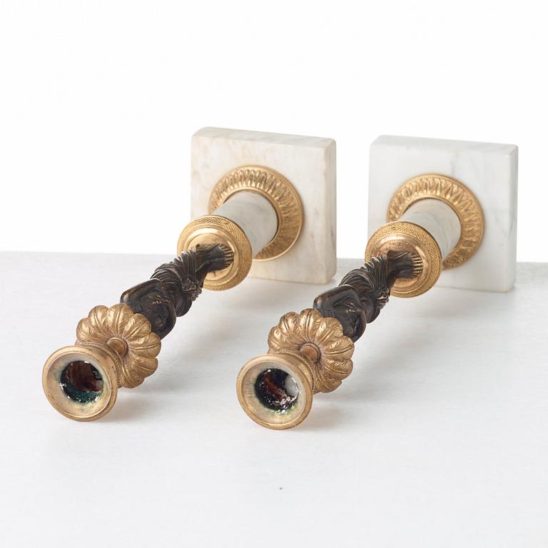 A pair of late Gustavian circa 1800 white marble and bronze candlesticks.