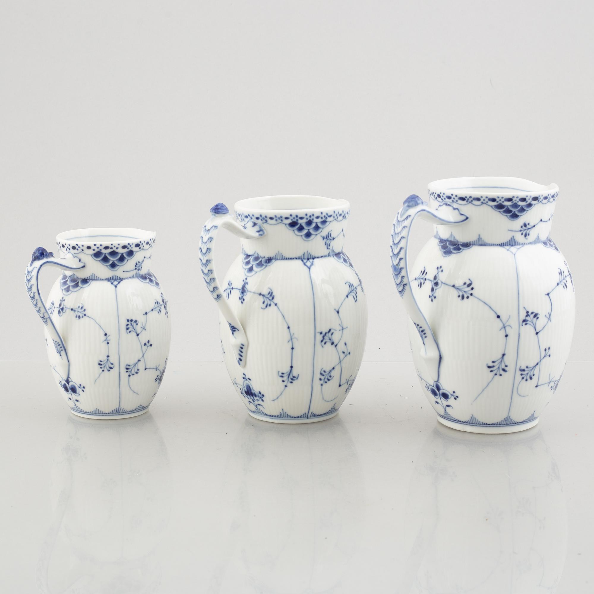 Three 'Blue Fluted Half Lace' / 'Musselmalet' porcelain jugs, Royal Copenhagen, model 562, 561, 763, 1898-1923 and 1962.