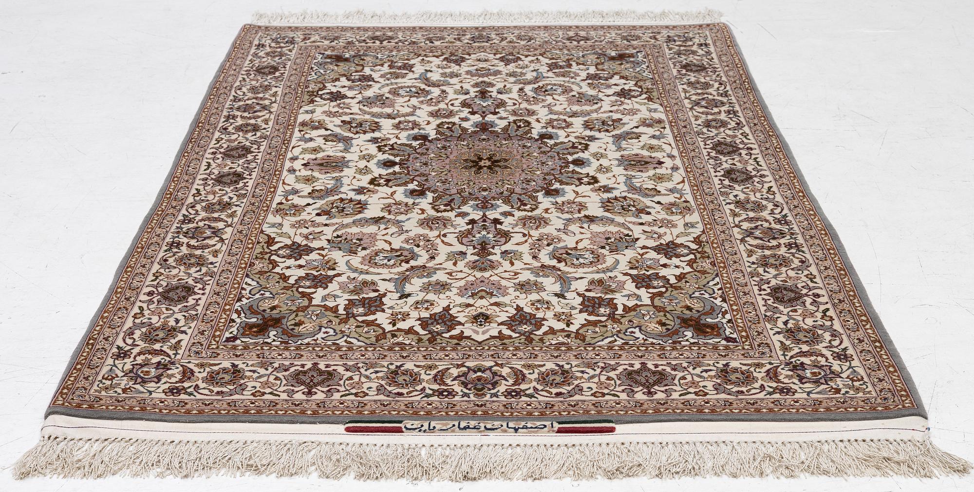 A semi-antique Isfahan rug, central Persia, signed Ghaffarian, c. 180 x 112 cm.