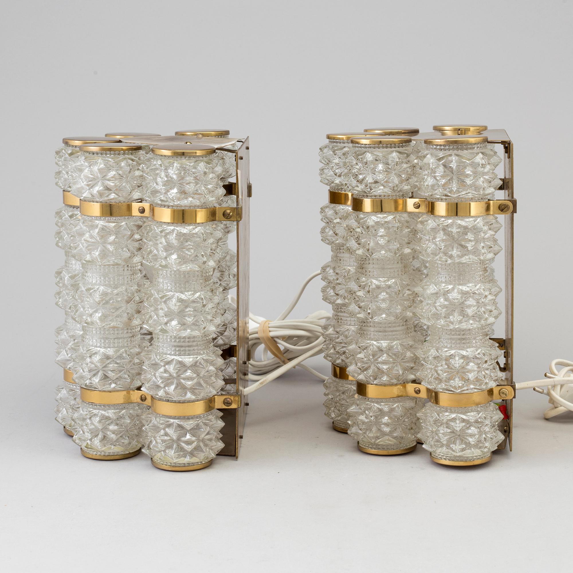 A pair of 1970's glass and brass wall lamps.