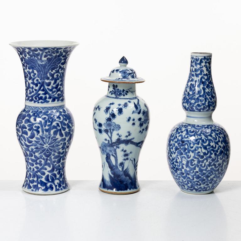 Two blue and white vases, Qing dynasty, 19th century and a blue and white vase with cover, 18th century.