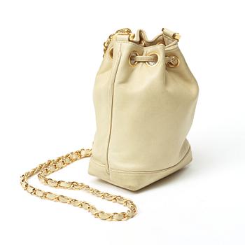 A 1980s cream colored shoulder bag by Chanel.