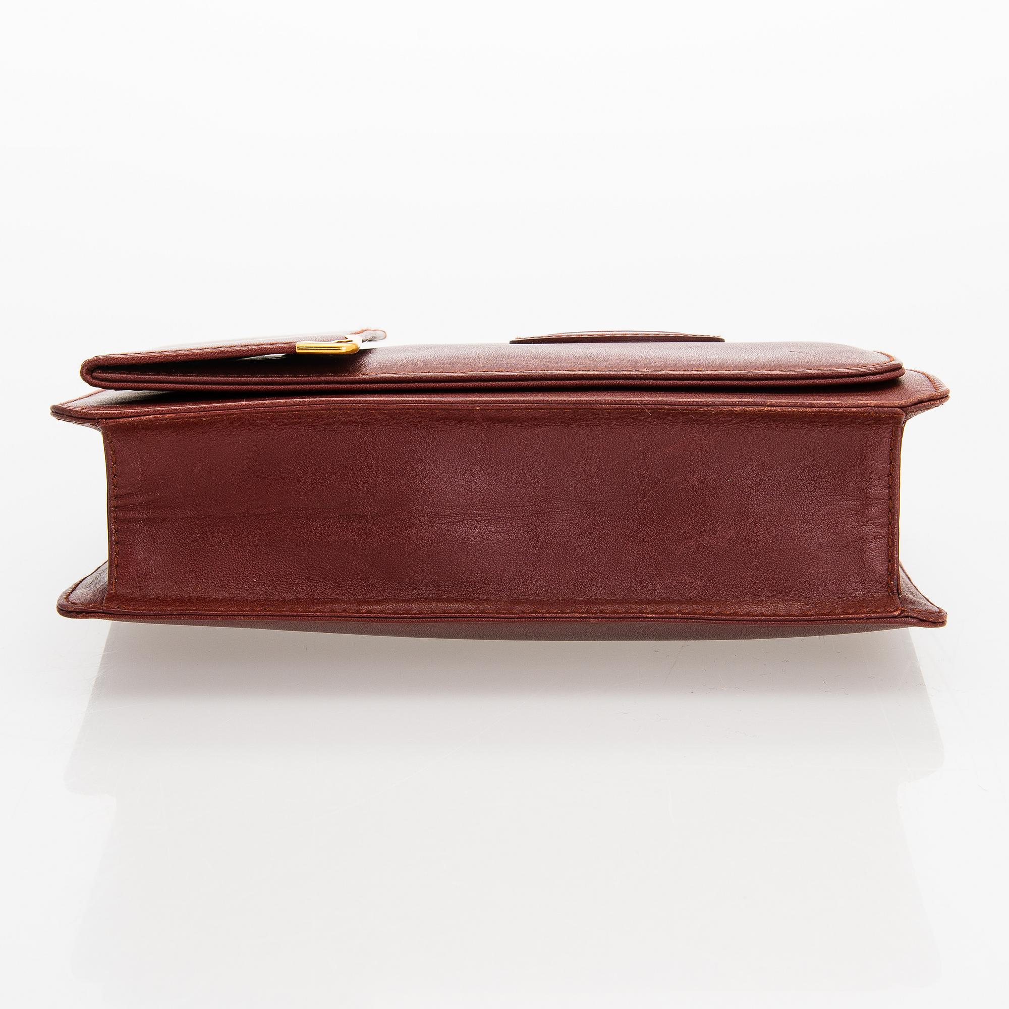 Must de Cartier bag clutch with accessories.