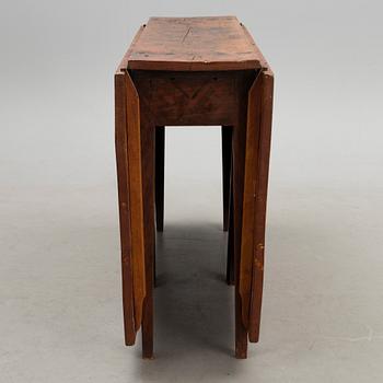 A 19th century folk art drop leaf table.