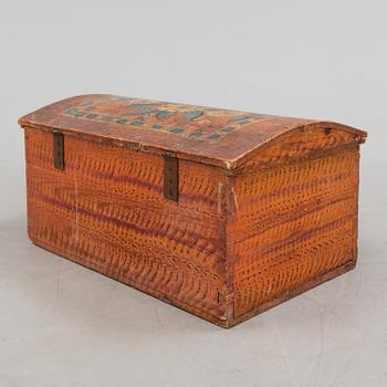 A wooden chest, dated 1856.