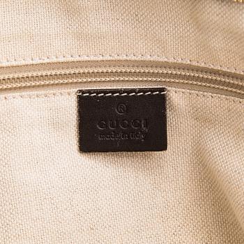 Gucci, a canvas tote bag.