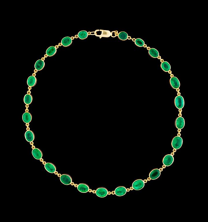A gold and emerald necklace.