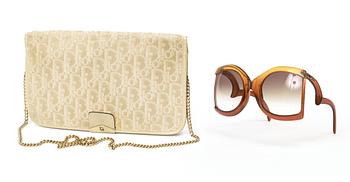 553. A clutch and sunglasses by Christian Dior.