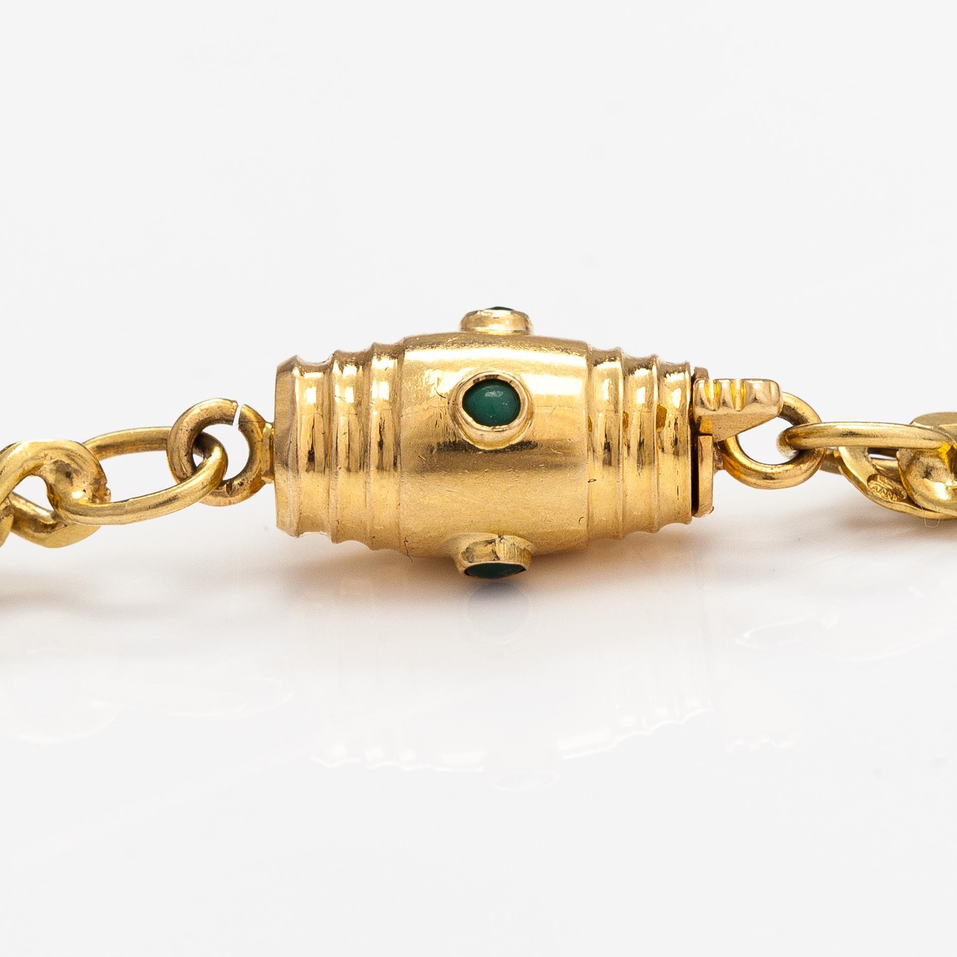 An 18K gold neckalce with stones. Erling Kaj Oy Ab, Helsinki 1977.