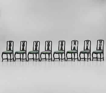 A set of eight black Swedish rococo chairs.