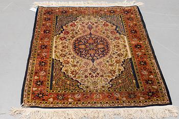 A rug, Old silk Hereke, ca 136 x 92 cm.