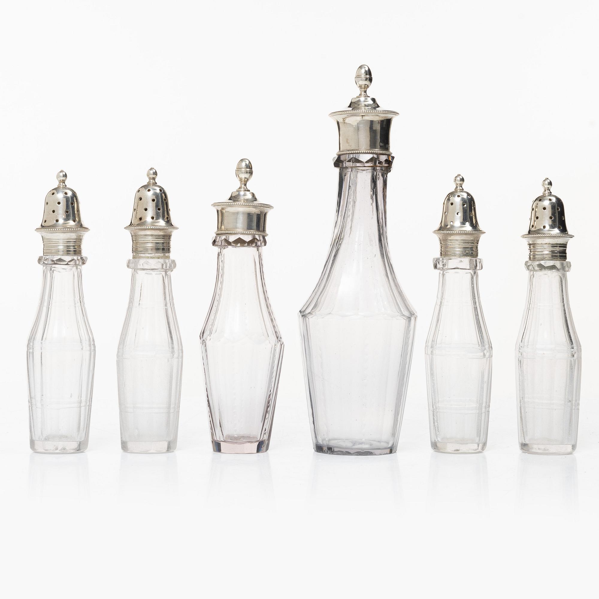Parts for a table centrepiece, six glass bottles, and seven lids in silver, marked Pehr Zethelius, Stockholm 1807.