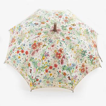 Gucci, a 'Flora' weekend bag and umbrella.