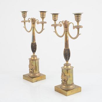 A pair of Swedish Empire two-branch gilt-brass candelabra, 1820's/30's.