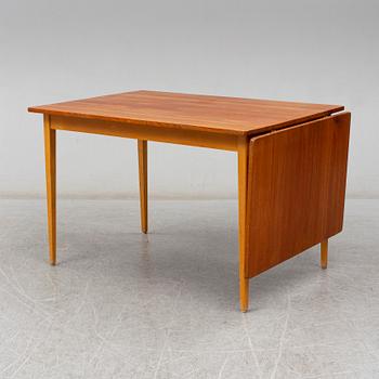 A 1960s teak veneered dining table.