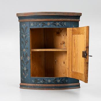 A folk art corner cabinet from Delsbo, Hälsingland, dated 1865.