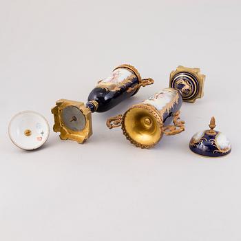 Pair of Sevres Chateau des Tuileries porcelain lidded urns, mid-19th century.