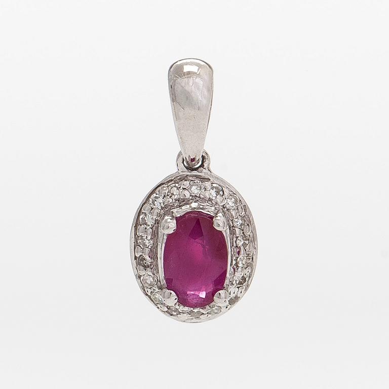 A 14K white gold pendant, with an oval faceted ruby and diamonds.