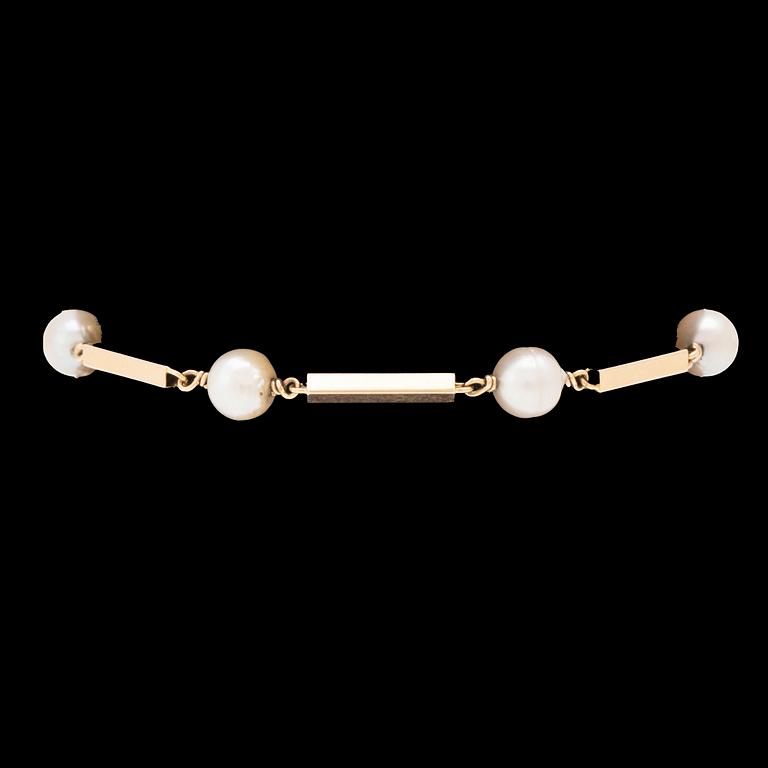 An 18K gold bracelet set with cultured pearls.
