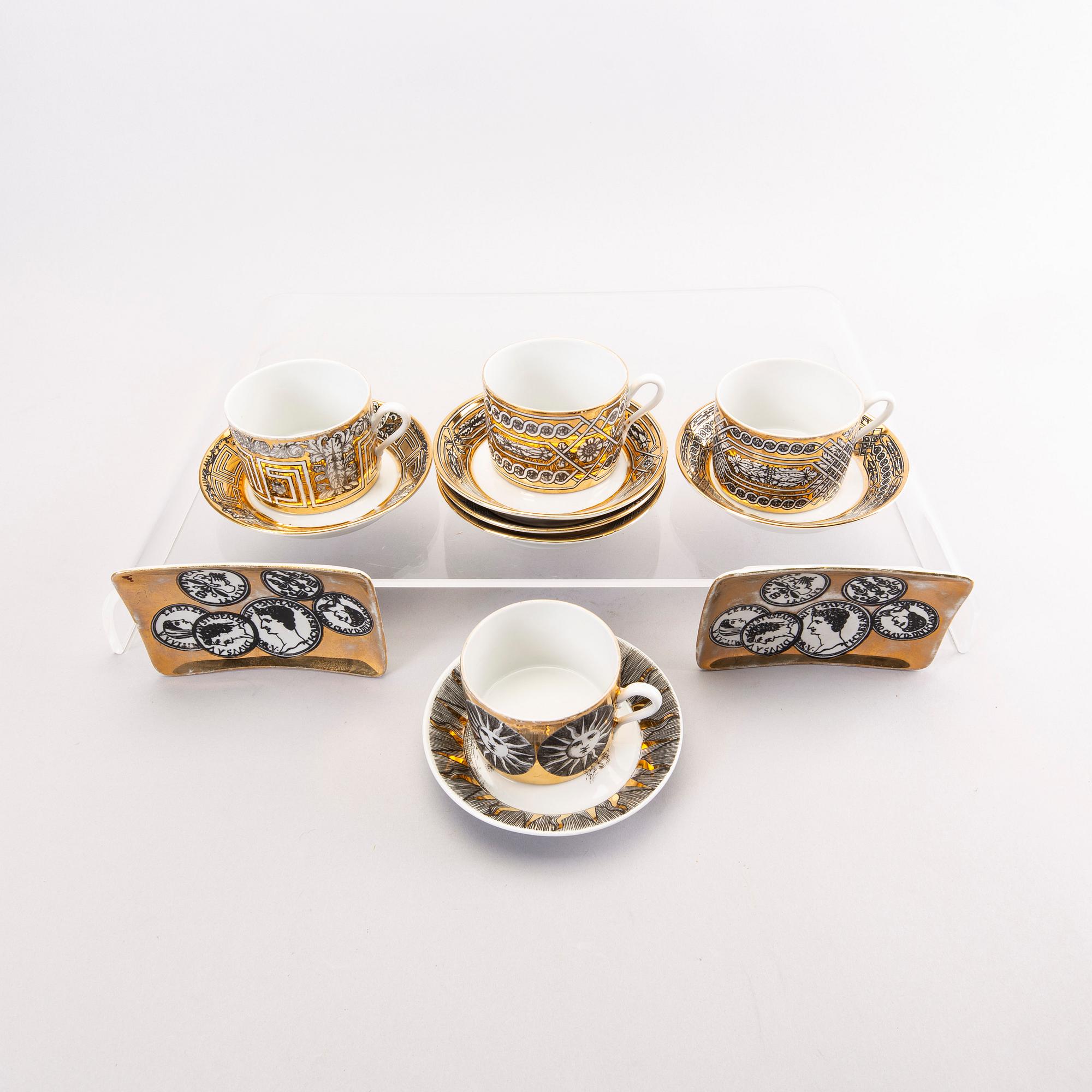 Piero Fornasetti a set of four coffee cups with saucers and two ashtrays.