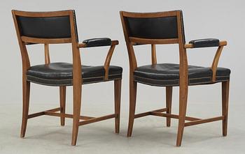 A pair of Josef Frank walnut and black leather armchairs, Svenskt Tenn, model 695.