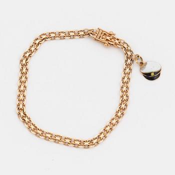 ARMBAND med en BERLOCK, 18K guld.