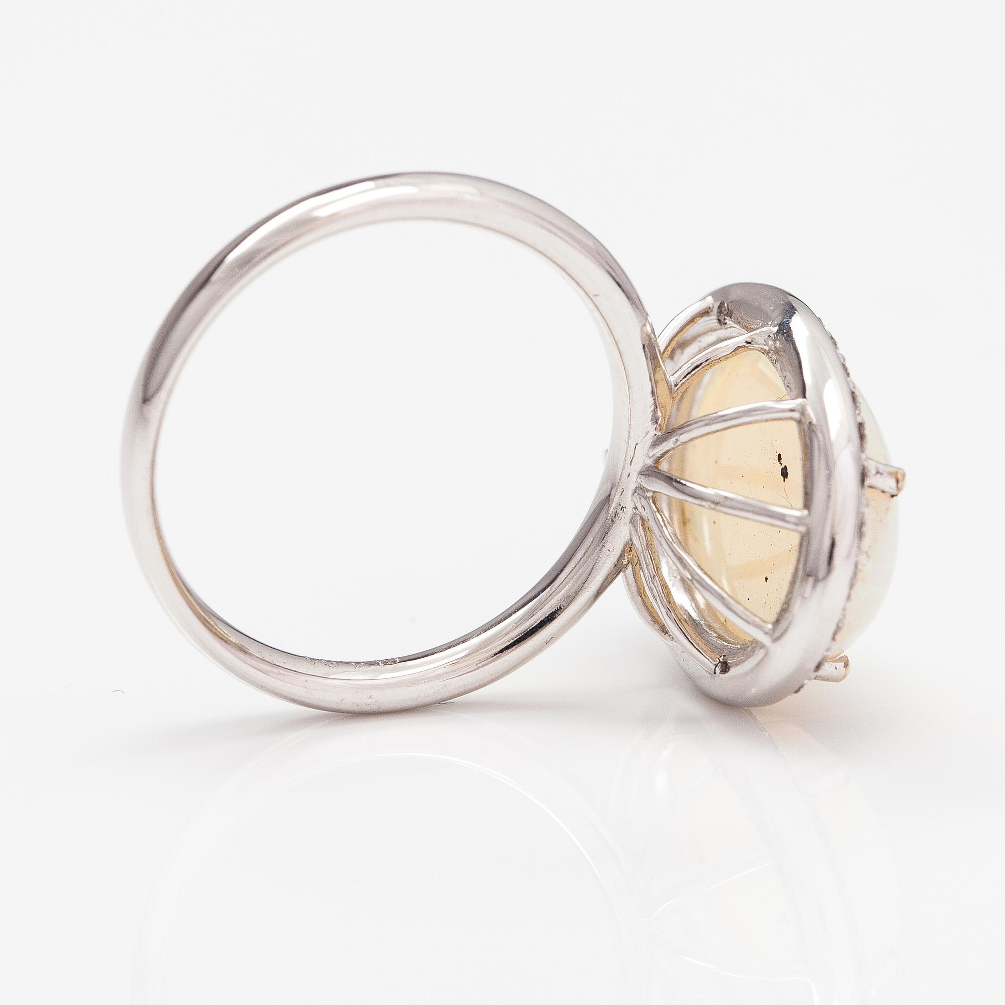 An 18K white gold ring with an opal ca. 4.64 ct and diamonds ca. 0.35 ct in total according to certificate.