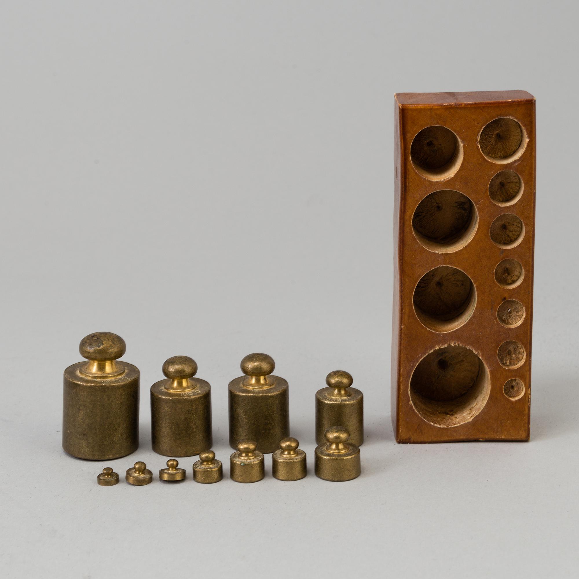 A 20th century cast iron balance with brass and iron weights, partly Skultuna, Sweden.