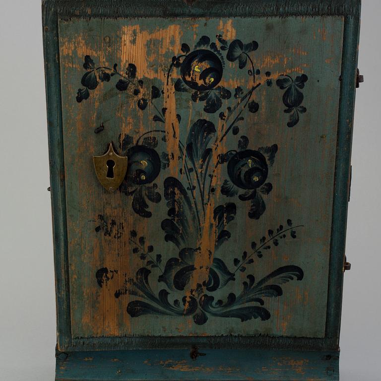 a oainted swedish wood wall cabinet, dated 1807.