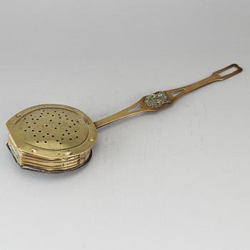 A brass chestnut roaster, 19th century.