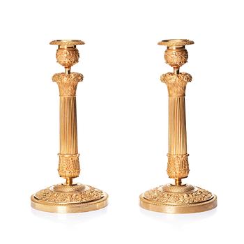 107. A pair of French gilded Empire candlesticks, early 19th century.